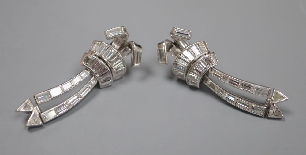 A pair of Art Deco style white metal, triangular and graduated baguette cut diamond set articulated drop earrings, 37mm,